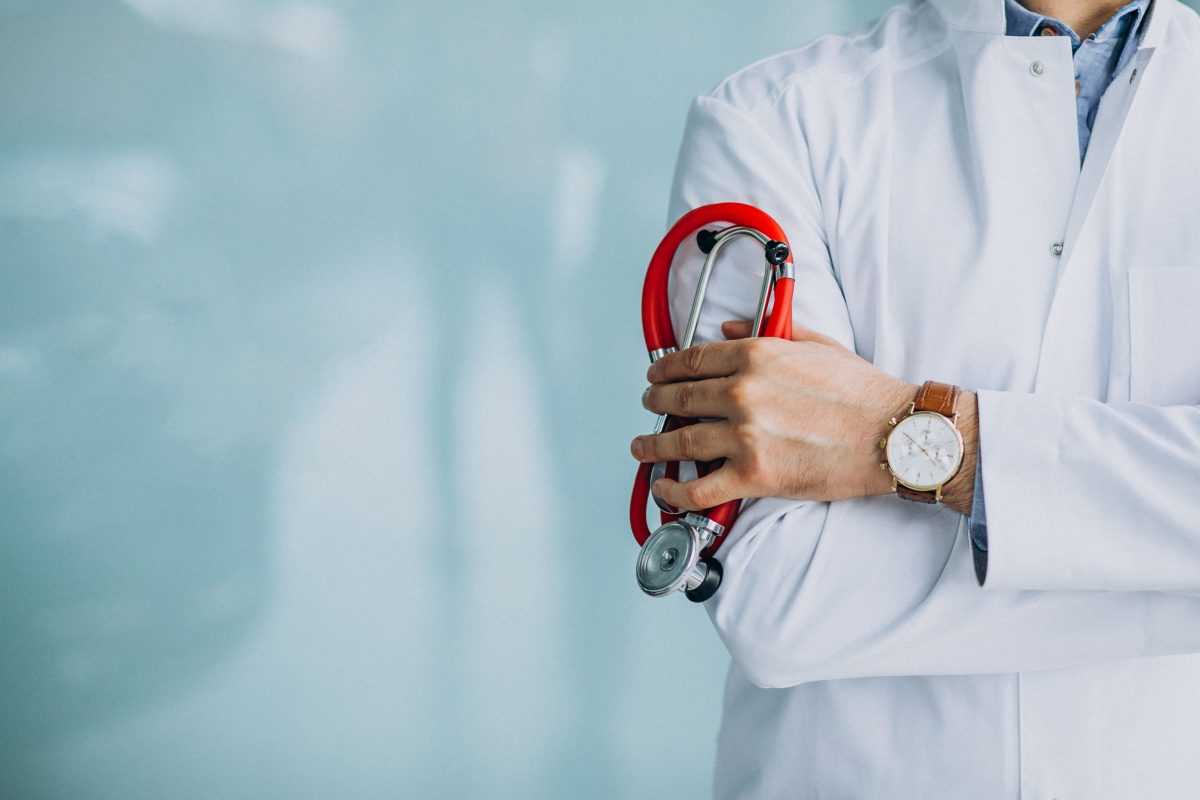 young handsome physician in a medical robe with stethoscope 1 scaled